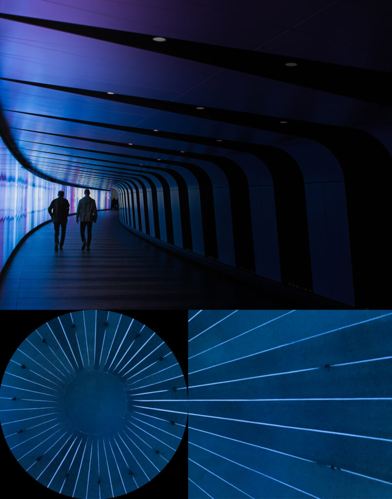 Two people in a futuristic blue hallway